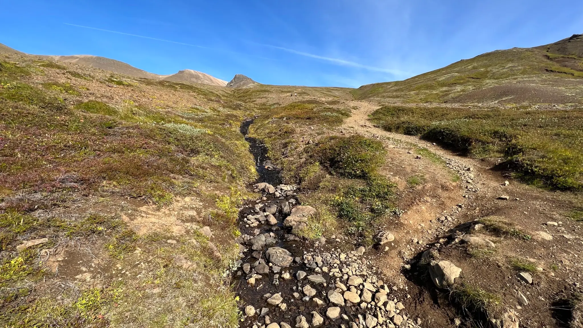 Cross small stream and head NNE