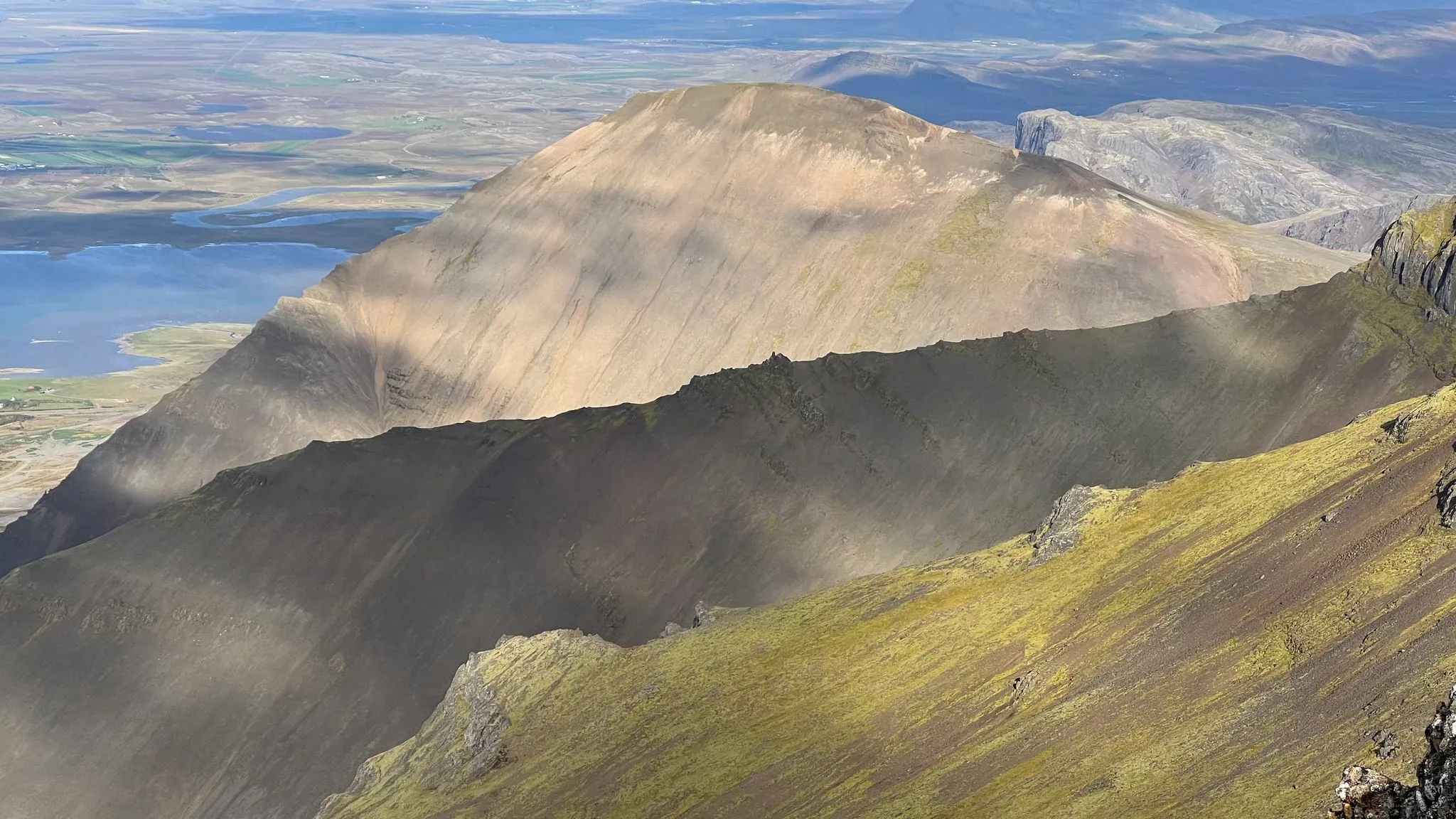 Wind-driven dust streaming off a scree mountain